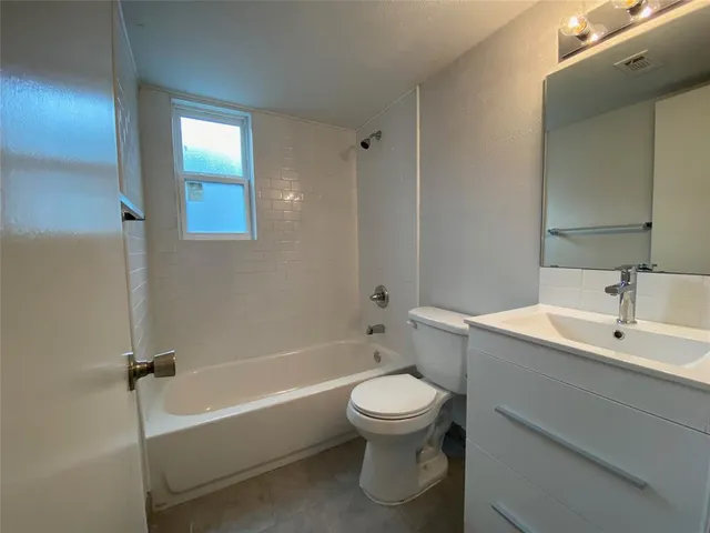 a bathroom with a toilet a sink and bathtub
