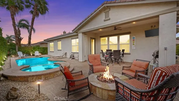 a view of a patio with couches table and chairs and potted plants