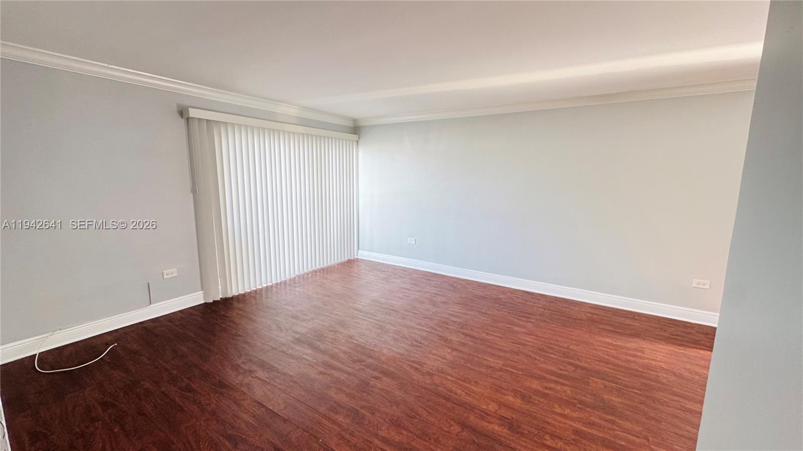 7226 Southwest 94th Place, Unit F7 Miami, FL 33173 - Photo 5 of 17 a view of an empty room with wooden floor