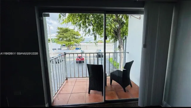 a view of a living room and floor to ceiling window