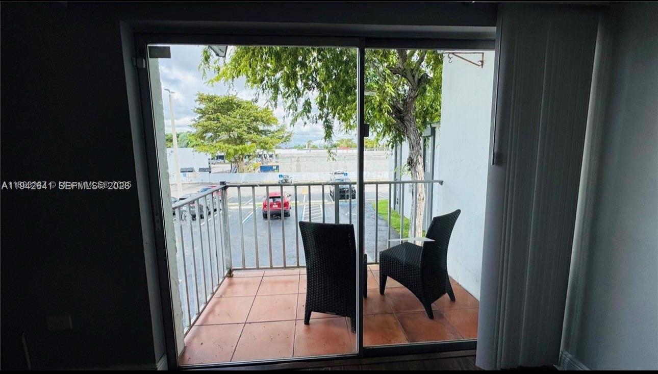 7226 Southwest 94th Place, Unit F7 Miami, FL 33173 - Photo 10 of 17 a view of a living room and floor to ceiling window