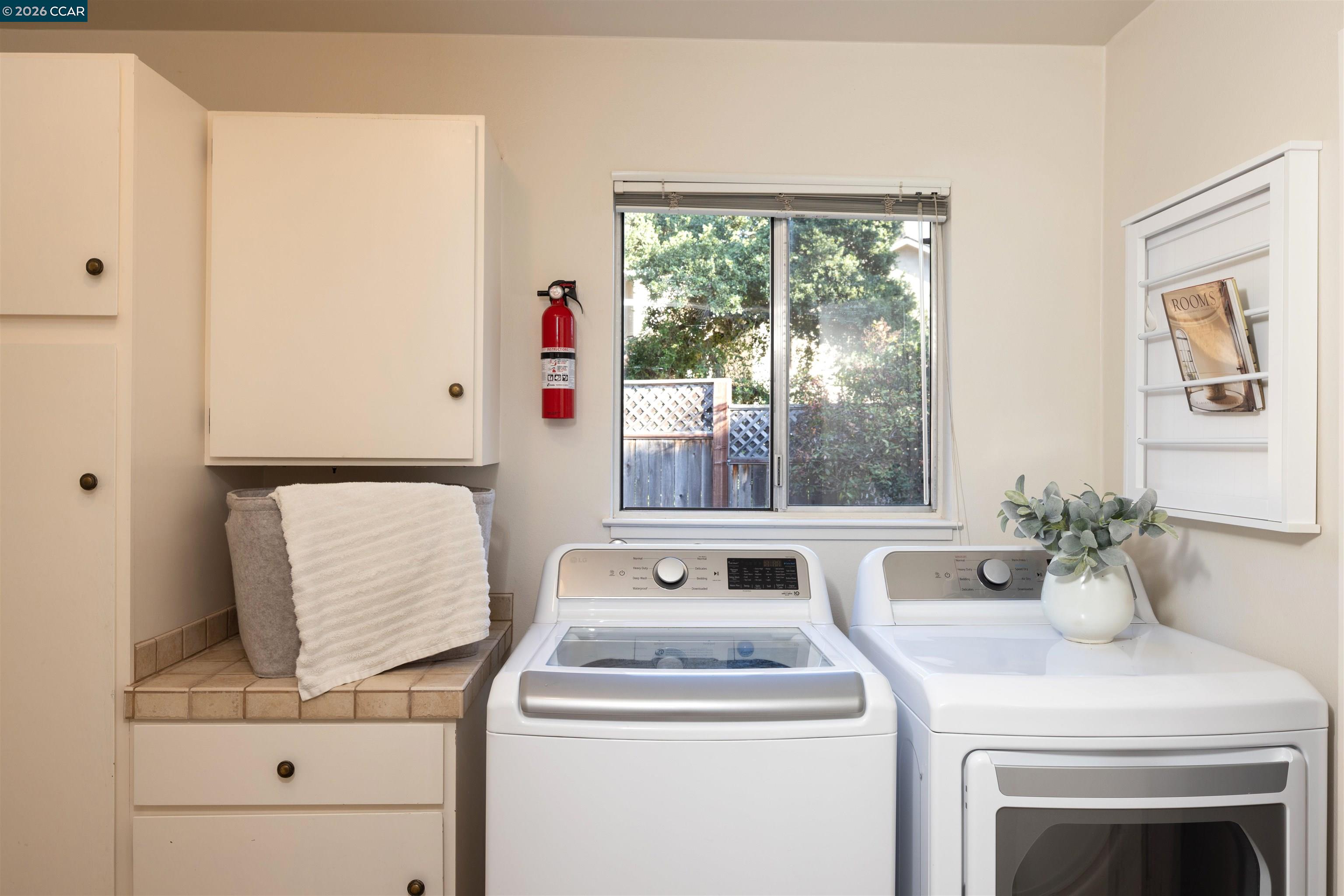 12 Marquard Road Carmel Valley, CA 93924 - Photo 18 of 36 a view of washer and dryer sitting on a cabinet