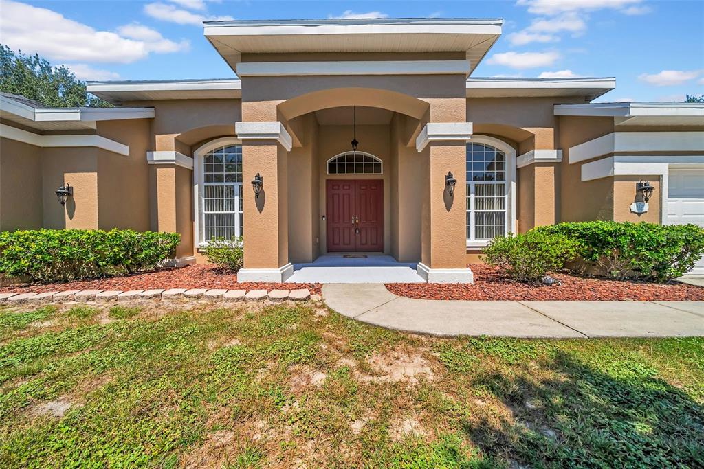 a front view of a house with garden
