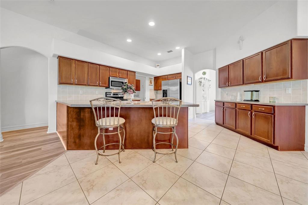 10177 Deer Street Spring Hill, FL 34608 - Photo 19 of 73 a kitchen with stainless steel appliances a table and chairs in it