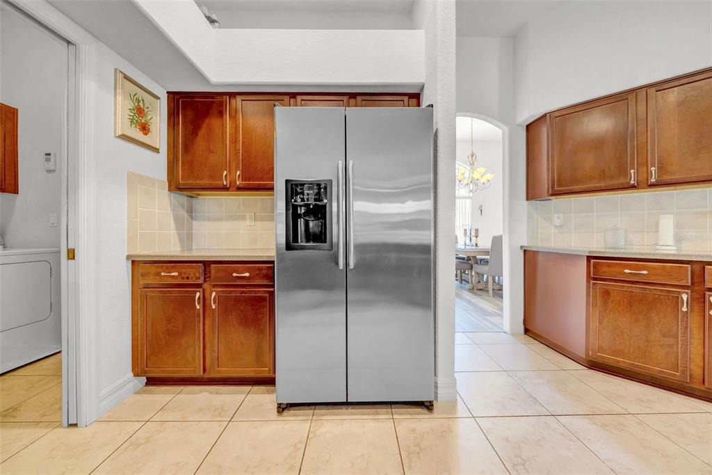 10177 Deer Street Spring Hill, FL 34608 - Photo 25 of 73 a kitchen with stainless steel appliances granite countertop a refrigerator and a stove