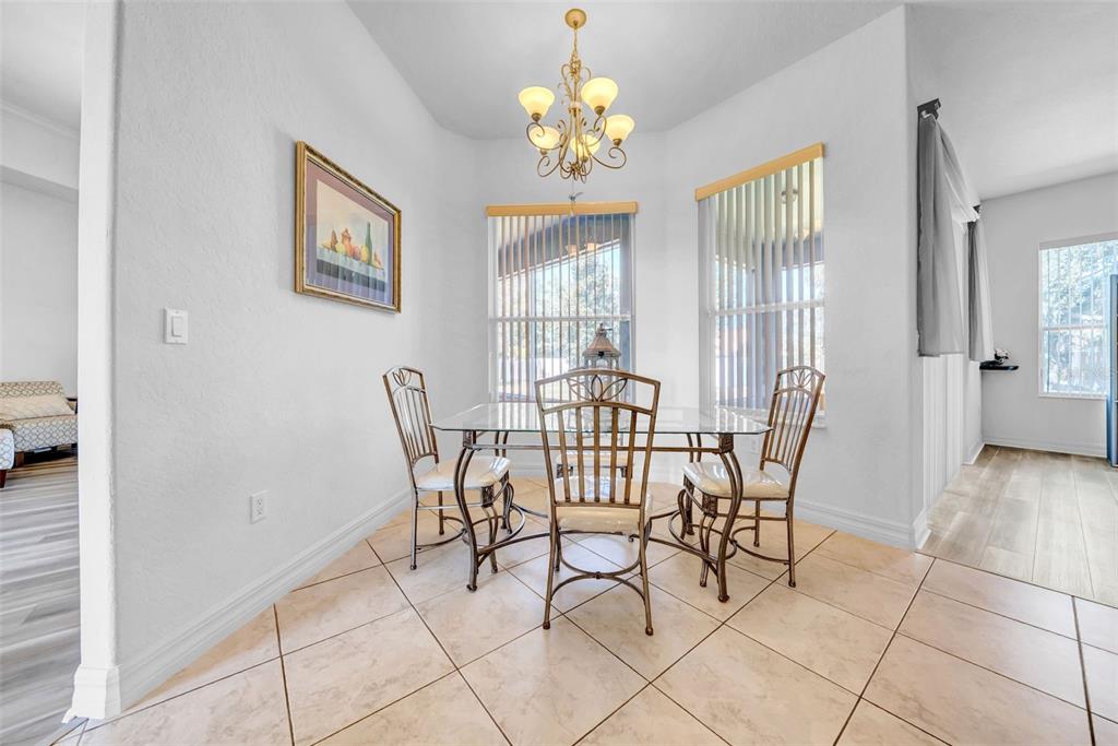 10177 Deer Street Spring Hill, FL 34608 - Photo 26 of 73 a view of a dining room with furniture and chandelier