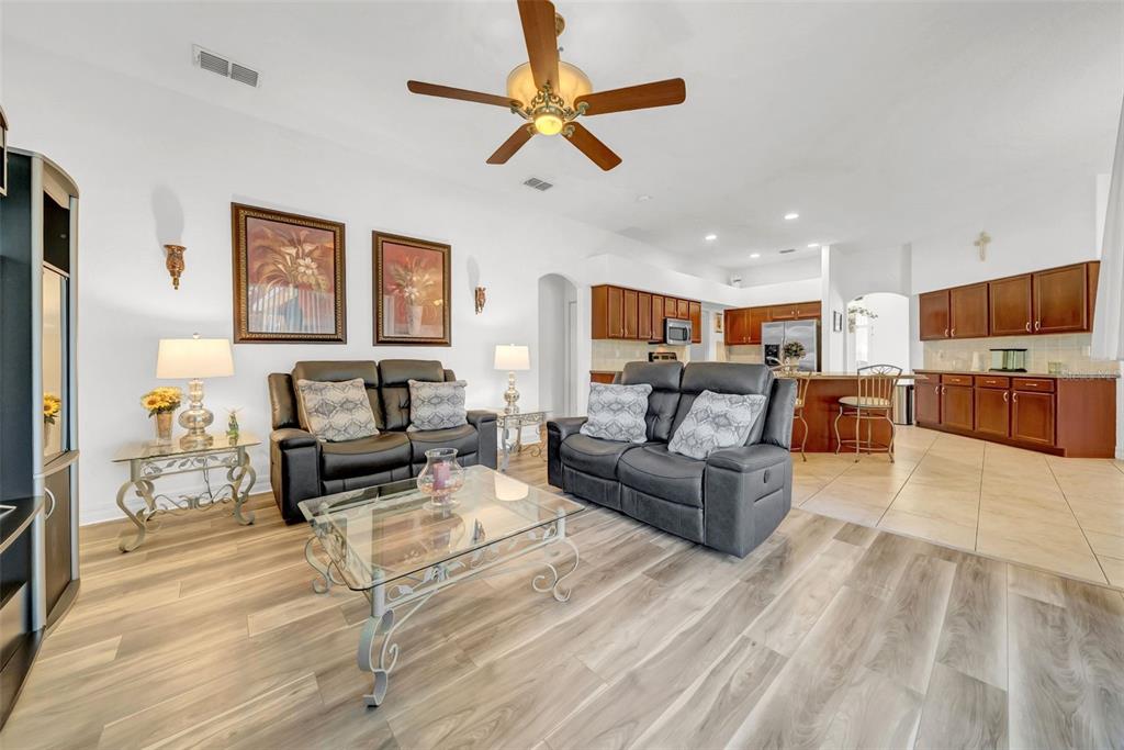 10177 Deer Street Spring Hill, FL 34608 - Photo 27 of 73 a living room with furniture and a flat screen tv