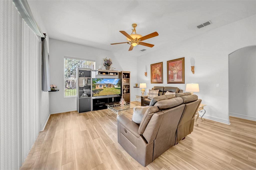 10177 Deer Street Spring Hill, FL 34608 - Photo 29 of 73 a living room with furniture and a fireplace