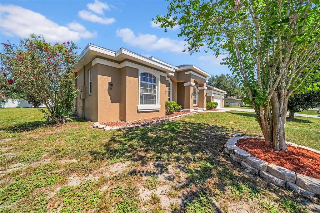 10177 Deer Street Spring Hill, FL 34608 - Photo 3 of 73 a front view of a house with garden
