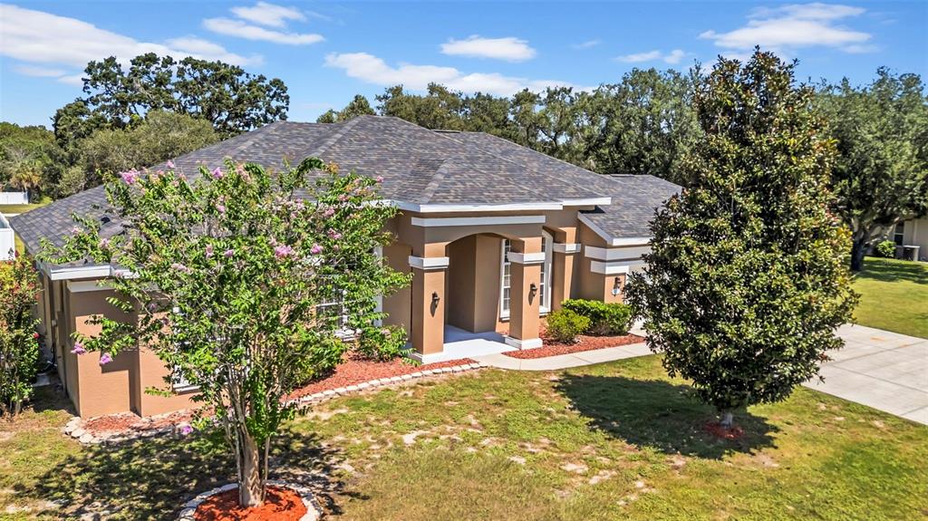10177 Deer Street Spring Hill, FL 34608 - Photo 5 of 73 a front view of a house with garden