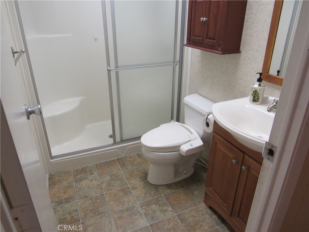27701 Murrieta Road, Unit 6 Menifee, CA 92586 - Photo 18 of 28 a bathroom with a sink toilet and shower