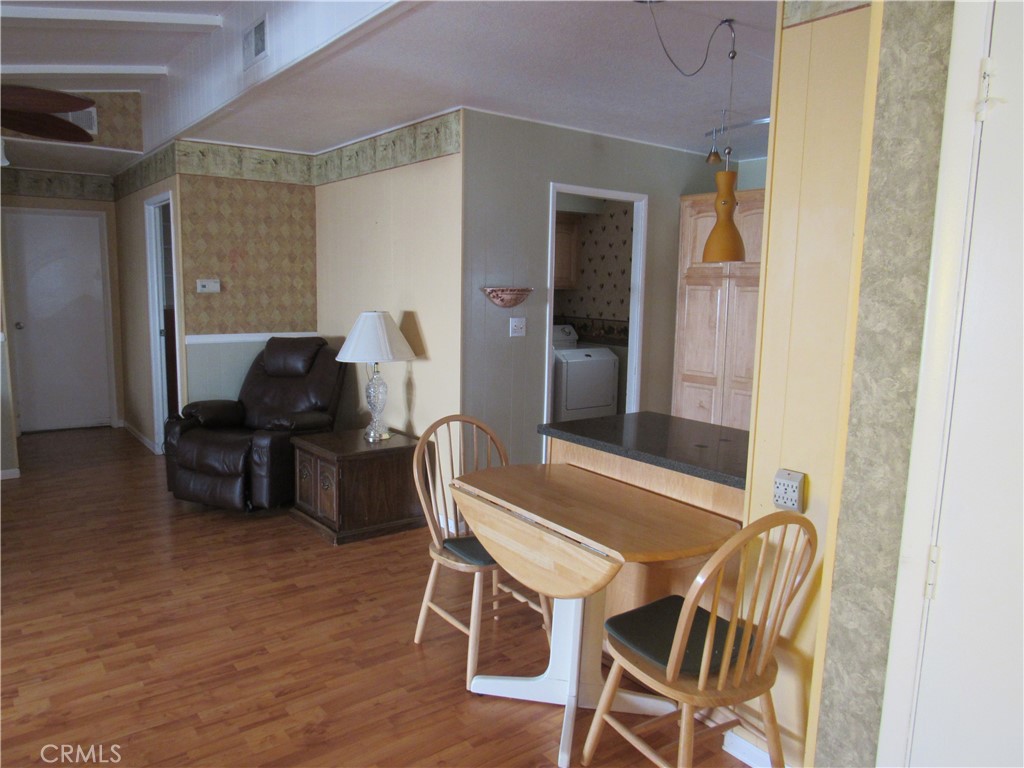 27701 Murrieta Road, Unit 6 Menifee, CA 92586 - Photo 9 of 28 a view of a dining room with furniture and wooden floor