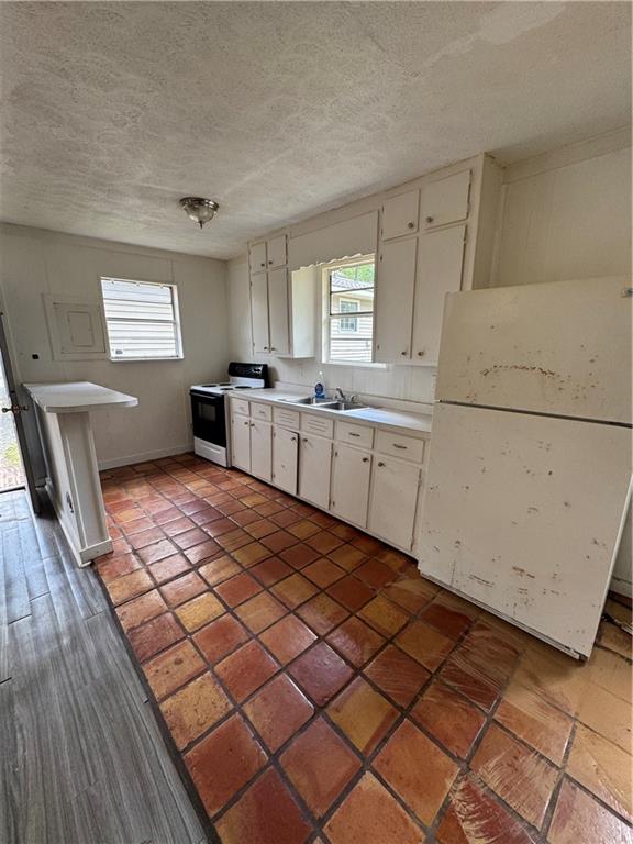 26 Plainview Drive Southwest Cartersville, GA 30120 - Photo 15 of 18 a kitchen with a sink a stove cabinets and wooden floor