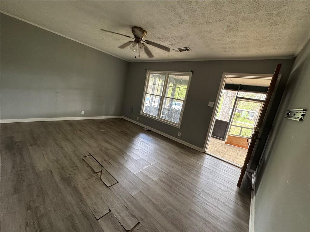 26 Plainview Drive Southwest Cartersville, GA 30120 - Photo 3 of 18 an empty room with wooden floor and windows