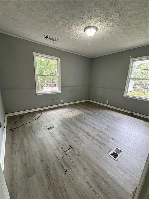 26 Plainview Drive Southwest Cartersville, GA 30120 - Photo 9 of 18 an empty room with wooden floor and windows