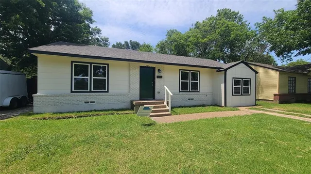 a front view of a house with a garden