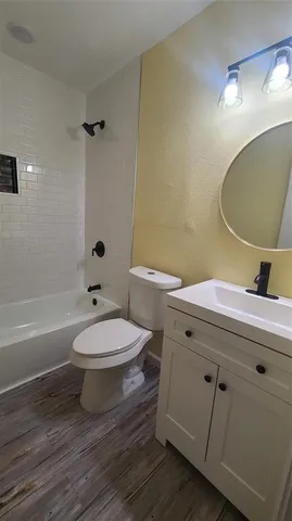 a bathroom with a toilet a sink and bathtub