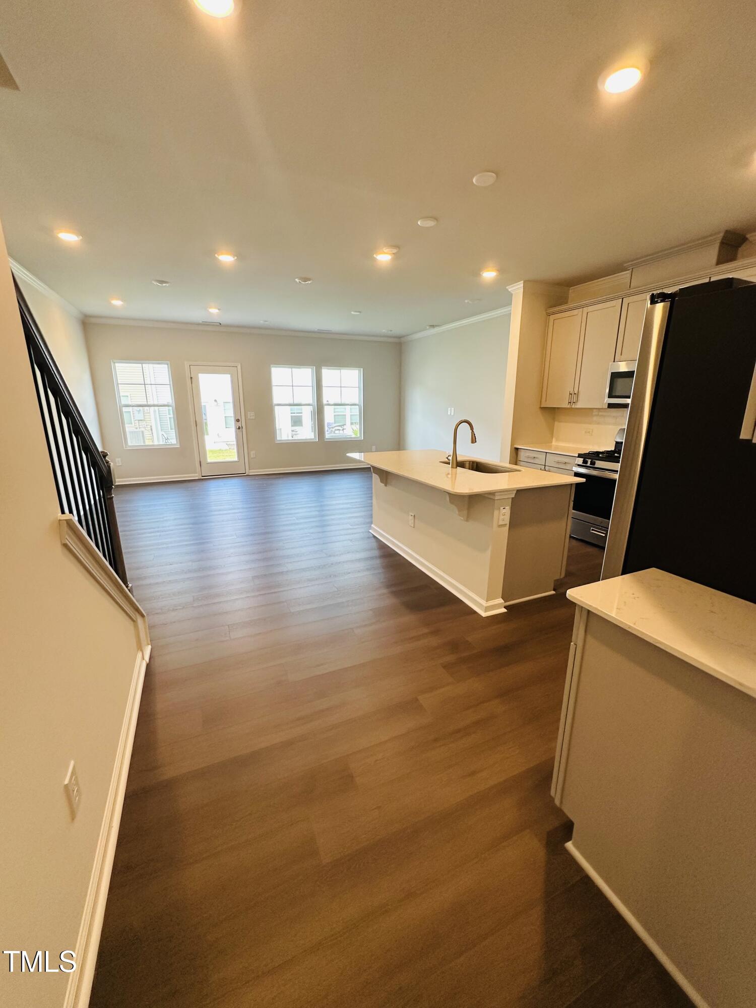 231 Paramount Drive Smithfield, NC 27577 - Photo 2 of 9 a view of a kitchen with kitchen island a large counter top space appliances and a window
