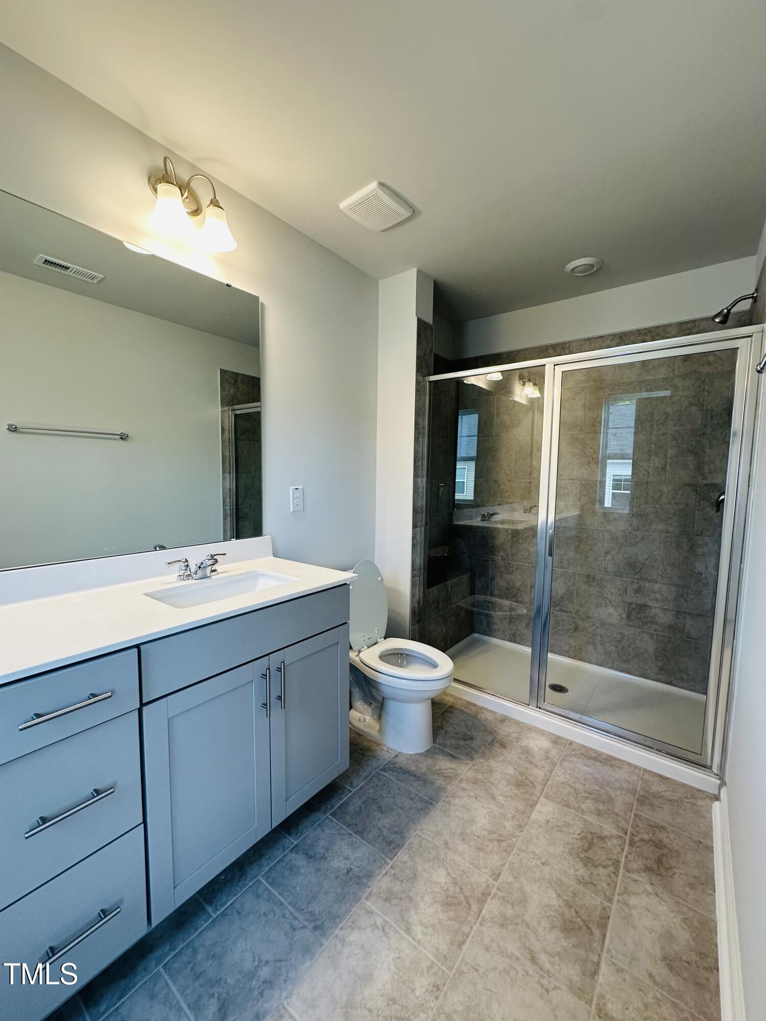 231 Paramount Drive Smithfield, NC 27577 - Photo 9 of 9 a bathroom with a toilet sink and shower