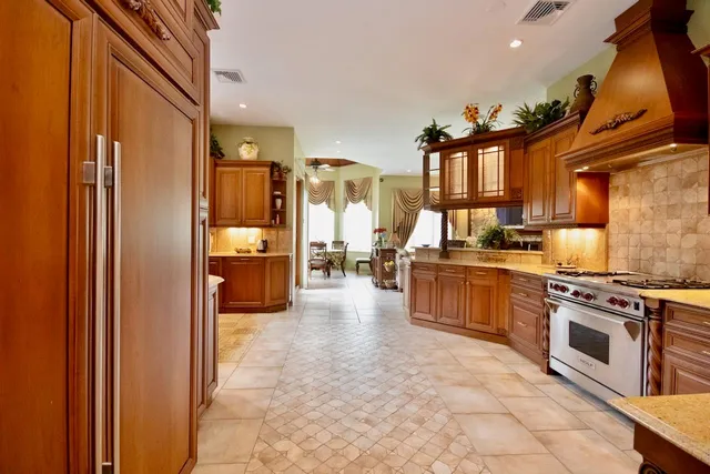 a kitchen with stainless steel appliances a stove a sink and a refrigerator