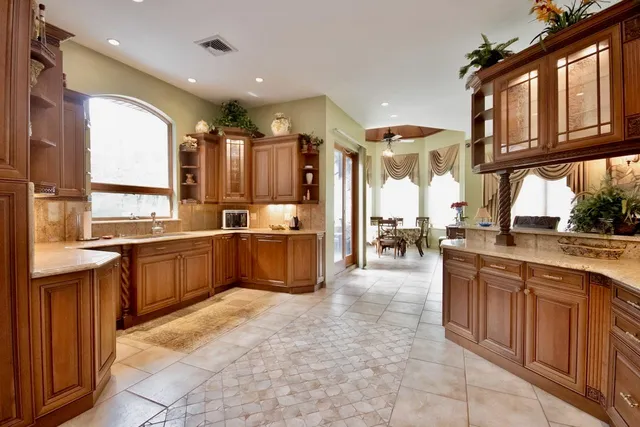 a large kitchen with stainless steel appliances lots of counter top space