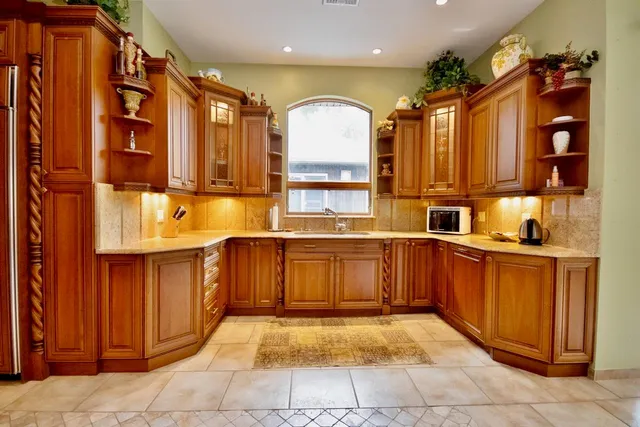 a kitchen with stainless steel appliances granite countertop a refrigerator and stove