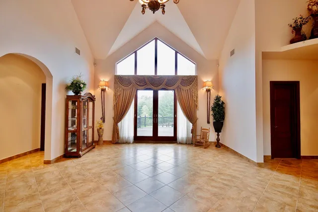 a view of a room with gym equipment and white walls