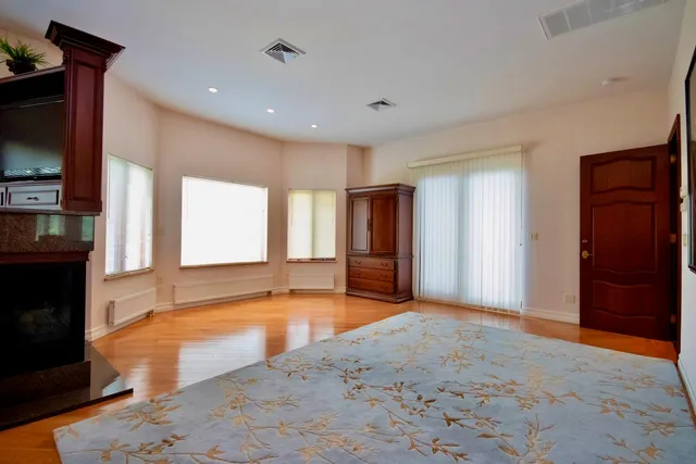 a bedroom with furniture and a mirror