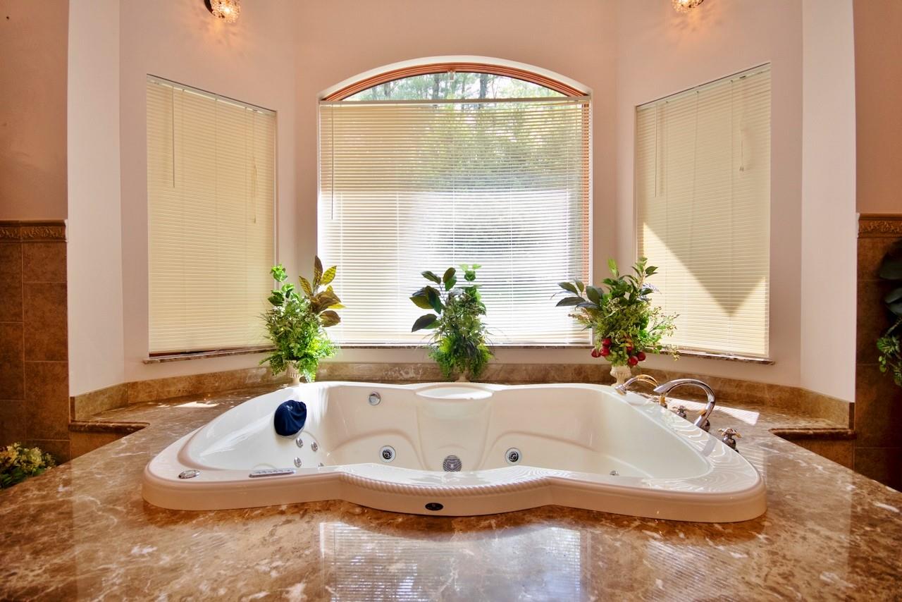 935 Starlight Road Monticello, NY 12701 - Photo 33 of 50 a bath tub sitting in a bathroom next to a window