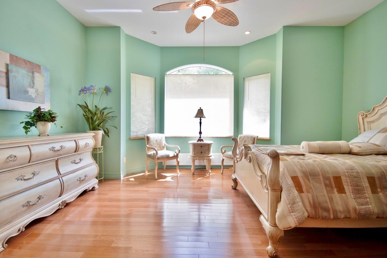 935 Starlight Road Monticello, NY 12701 - Photo 36 of 50 a spacious bedroom with a large bed and a chandelier