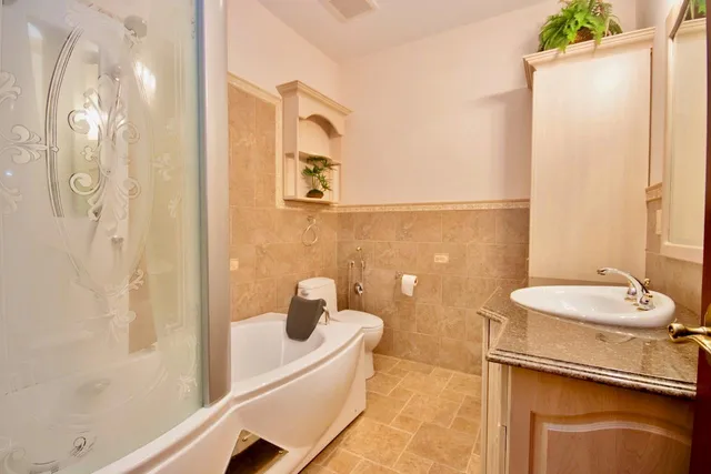 a bathroom with a sink a toilet and shower