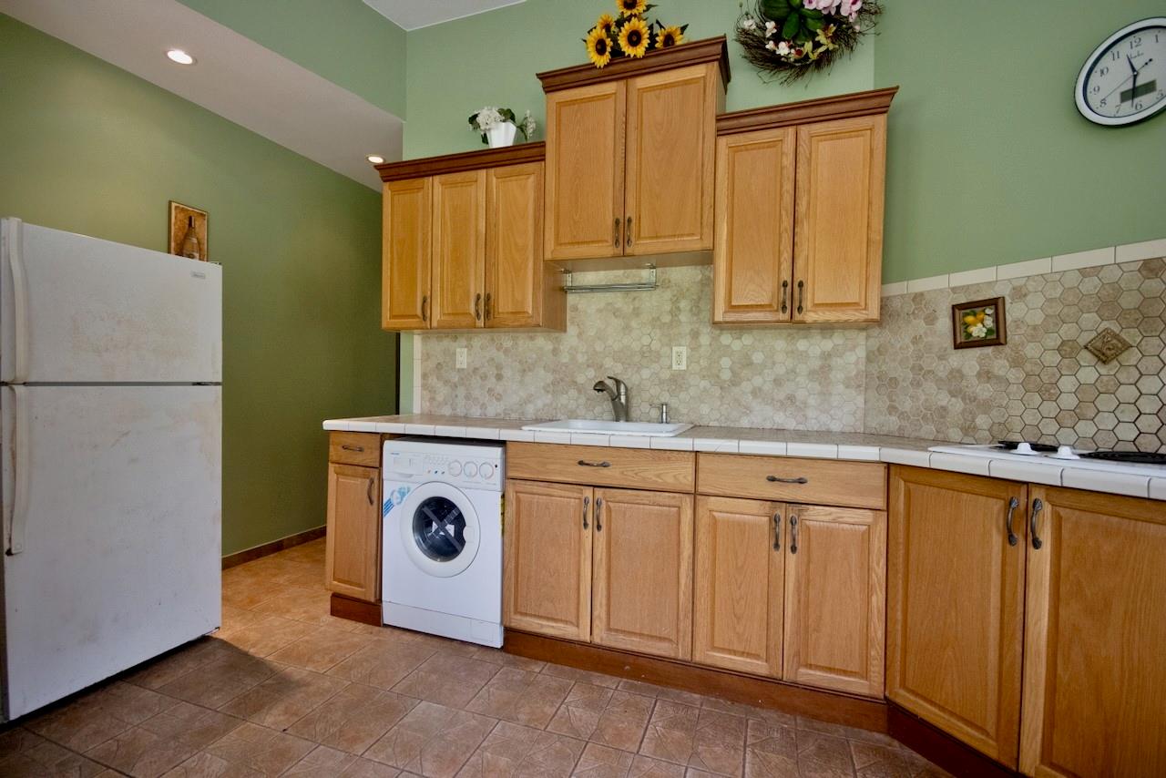 935 Starlight Road Monticello, NY 12701 - Photo 44 of 50 a kitchen with stainless steel appliances granite countertop a refrigerator a stove and a sink