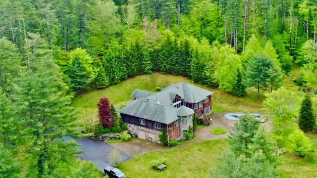 an aerial view of a house having swimming pool with a yard