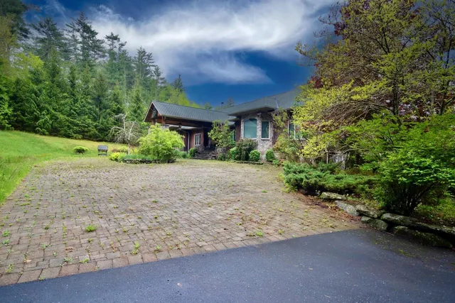 a front view of a house with a yard and a garage