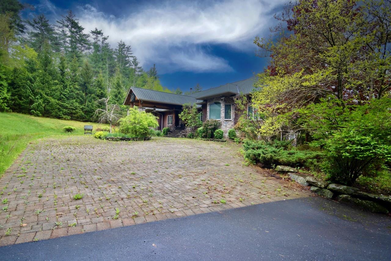 935 Starlight Road Monticello, NY 12701 - Photo 9 of 50 a front view of a house with a yard and a garage