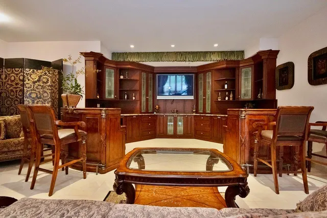 a living room with furniture pool table and flat screen tv