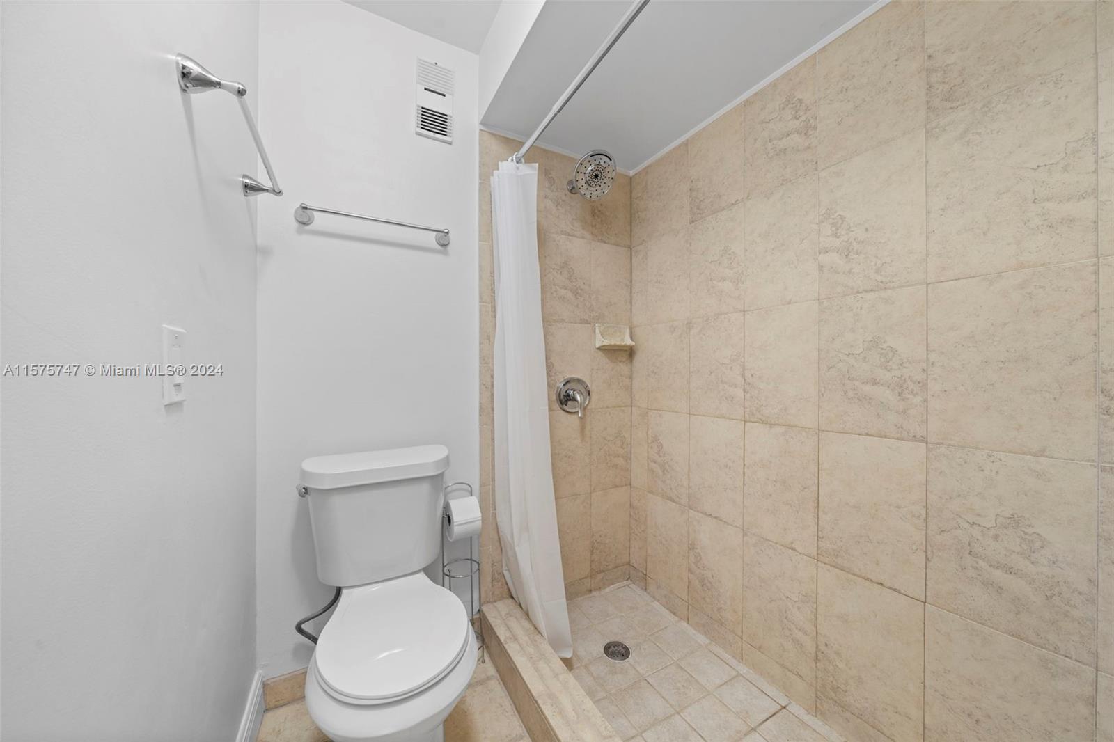 13298 Southwest 112th Terrace, Unit 461 Miami, FL 33186 - Photo 16 of 35 a white toilet sitting next to a shower
