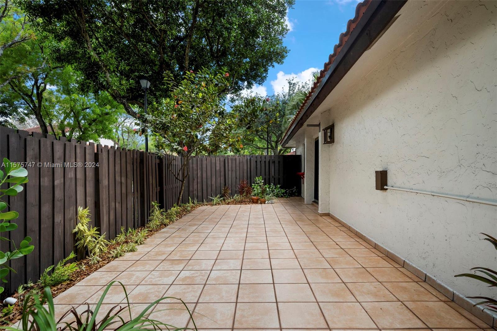 13298 Southwest 112th Terrace, Unit 461 Miami, FL 33186 - Photo 22 of 35 a view of backyard with wooden fence