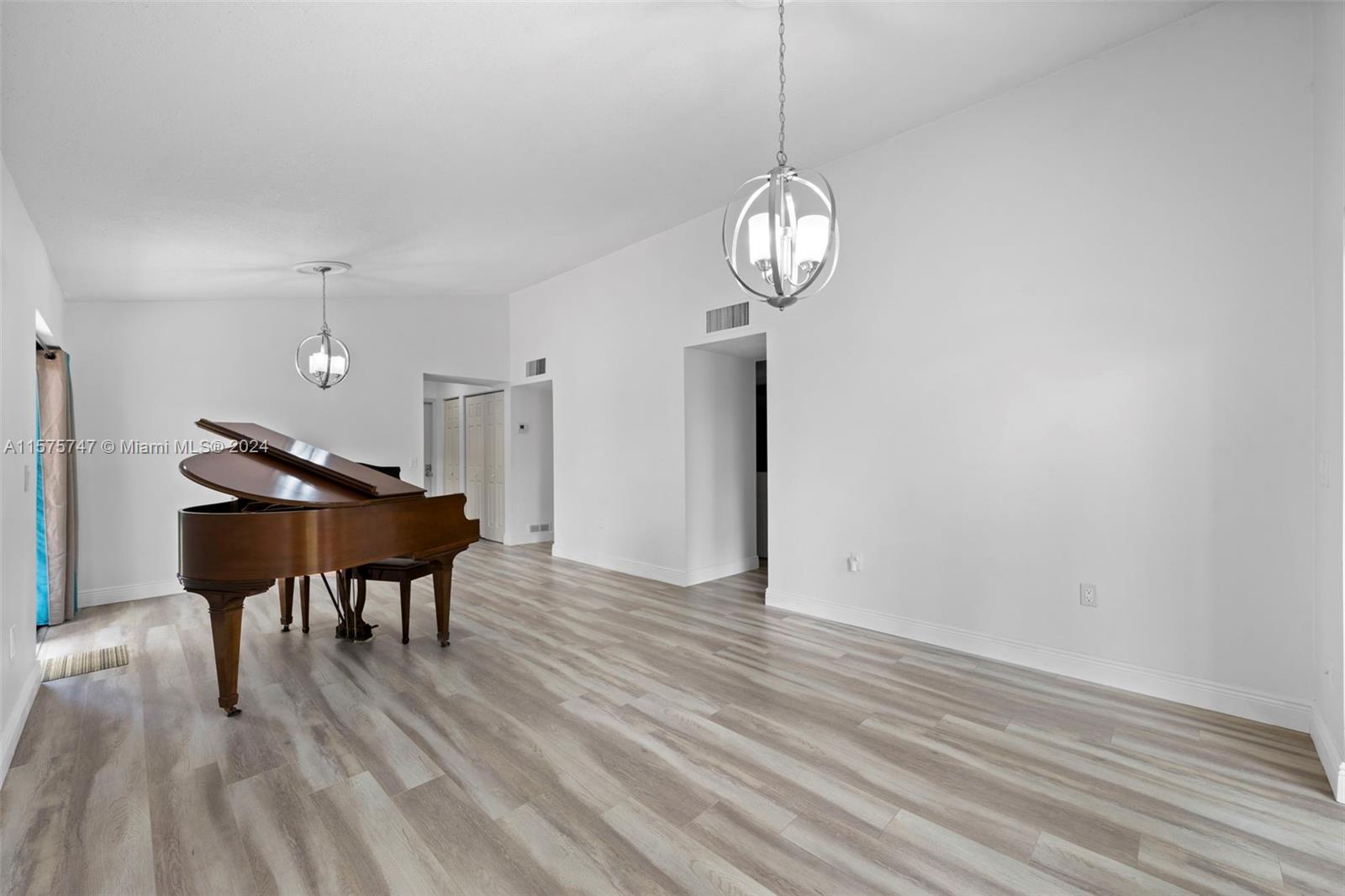 13298 Southwest 112th Terrace, Unit 461 Miami, FL 33186 - Photo 7 of 35 a view of a dining room with furniture and wooden floor