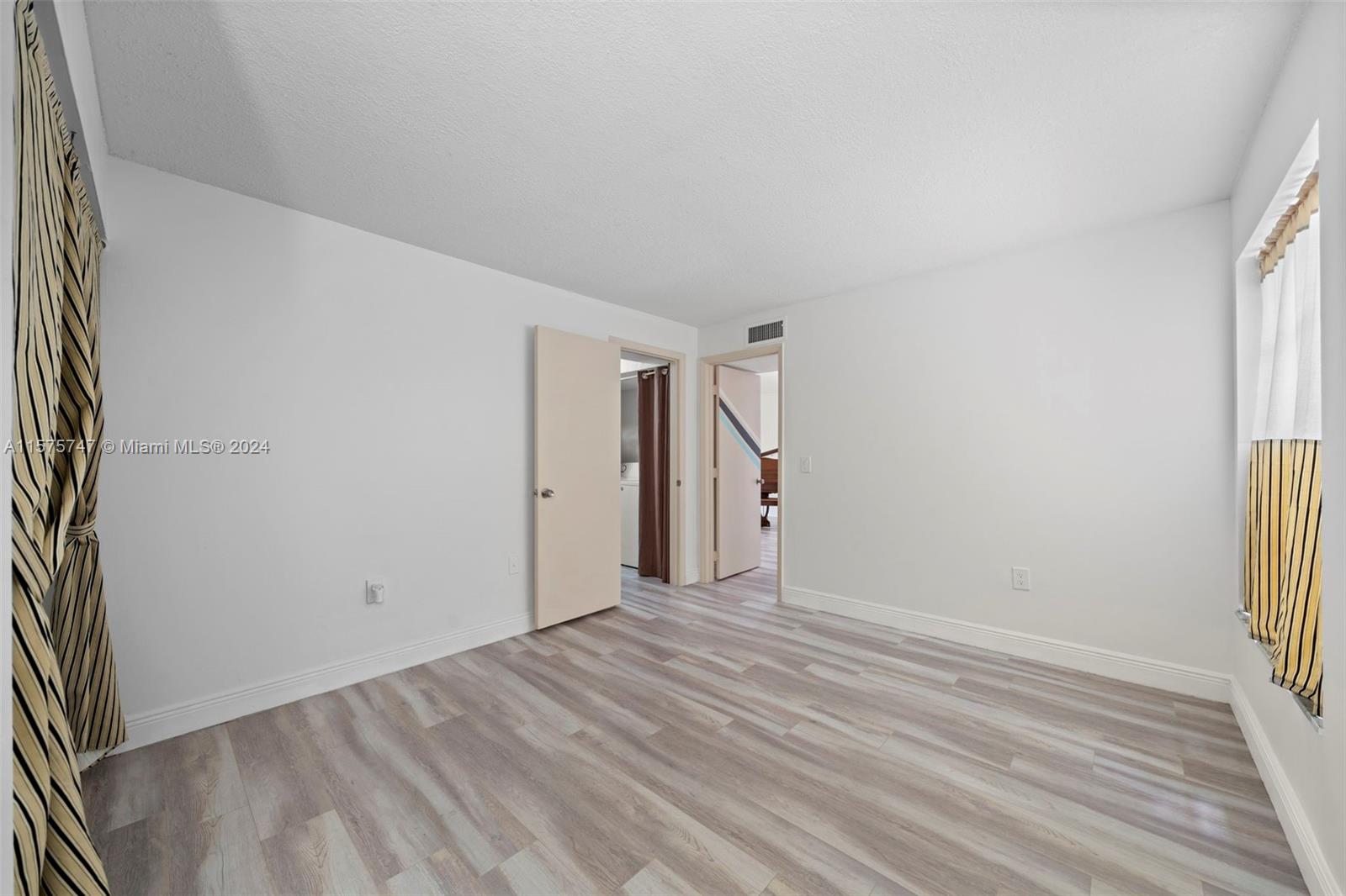 13298 Southwest 112th Terrace, Unit 461 Miami, FL 33186 - Photo 9 of 35 a view of a room with wooden floor and a window