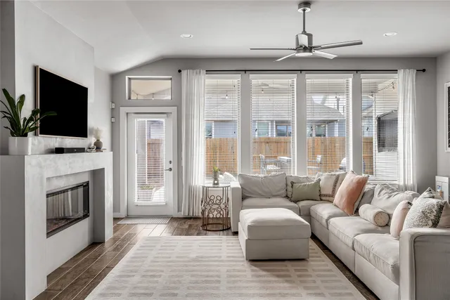 a large kitchen with stainless steel appliances kitchen island granite countertop a dining table chairs and a refrigerator