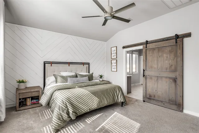 a spacious bedroom with a large bed and a flat tv screen on dresser