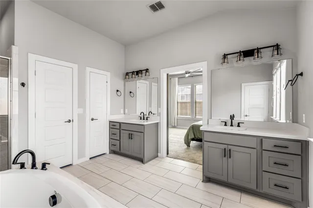 a spacious bathroom with a bathtub and a sink