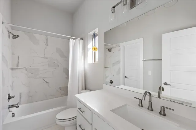 a bedroom with a bed and a night stand