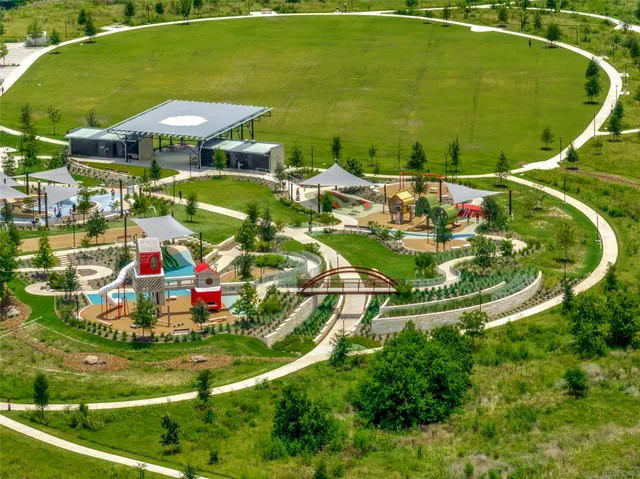 an aerial view of a house with a garden and swimming pool
