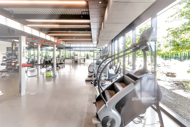 a gym room with lots of dining room and chandelier