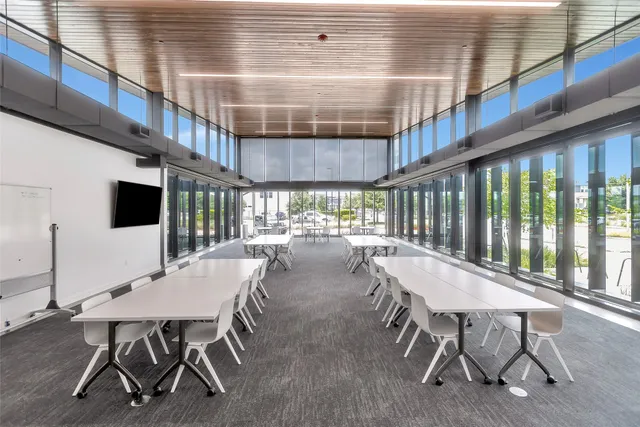 a dining room with furniture and a floor to ceiling window
