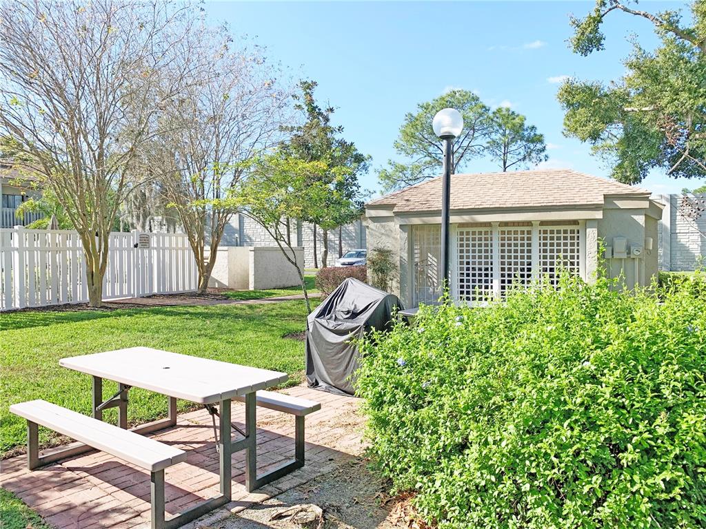 125 Springwood Circle, Unit D Longwood, FL 32750 - Photo 15 of 21 a view of a chair and table in backyard of the house