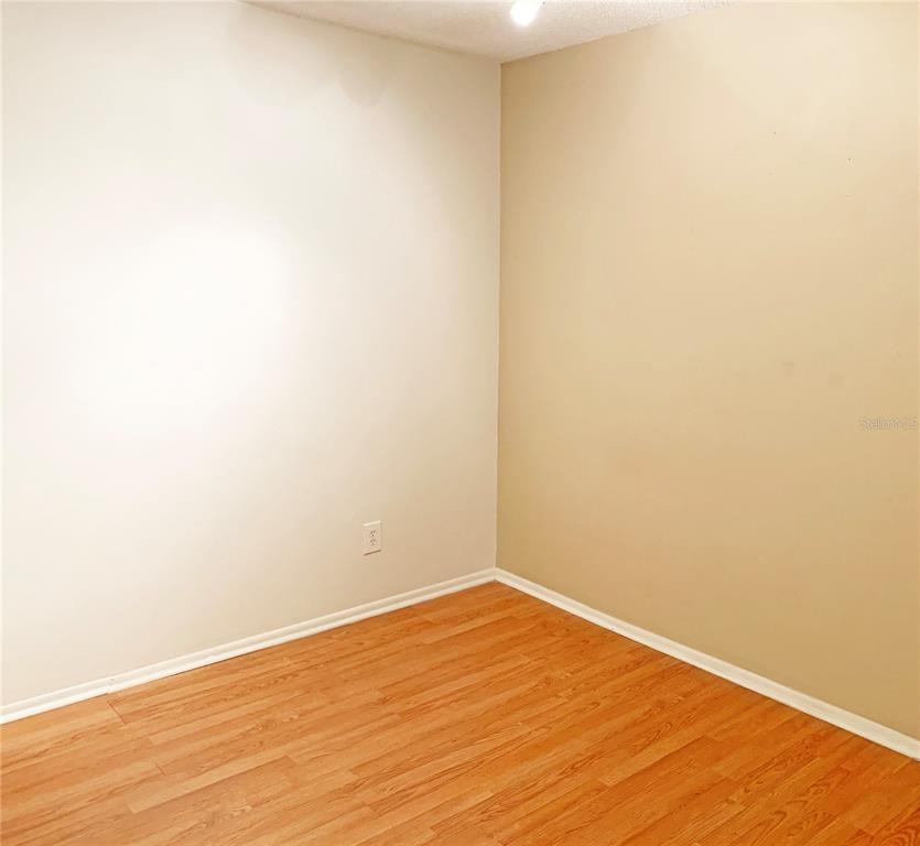125 Springwood Circle, Unit D Longwood, FL 32750 - Photo 5 of 21 a view of an empty room with wooden floor
