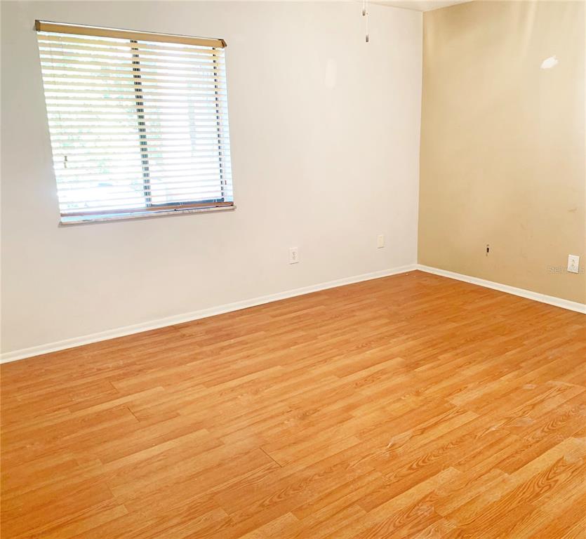 125 Springwood Circle, Unit D Longwood, FL 32750 - Photo 6 of 21 an empty room with wooden floor and windows